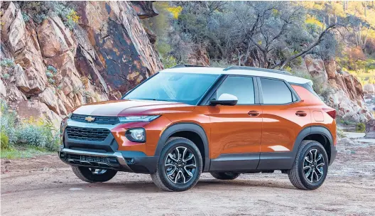  ?? JIM FRENAK/CHEVROLET PHOTOS ?? One of four new colors, Vivid Orange Metallic, with a white-painted roof, gives the Chevrolet Trailblaze­r a far greater presence than it might otherwise have.