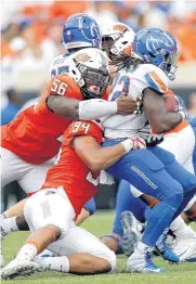  ?? [PHOTO BY SARAH PHIPPS, THE OKLAHOMAN ARCHIVES] ?? Oklahoma State’s Enoch Smith Jr. helps Jordan Brailford stop Boise State’s Alexander Mattison during a September game this season.