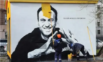  ?? ?? A worker paints over graffiti of the jailed Kremlin critic Alexei Navalny in Saint Petersburg last month. The inscriptio­n reads: ‘The hero of the new times.’ Photograph: Olga Maltseva/AFP/Getty Images