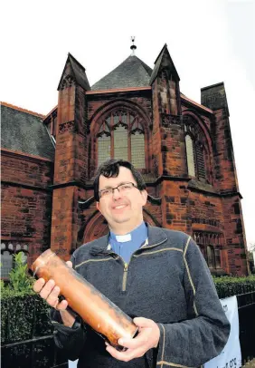  ??  ?? Minister
Alistair oversaw the opening of a time capsule at the church in 2013