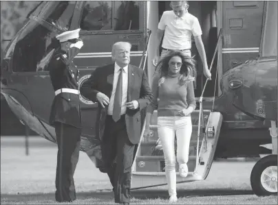  ?? AP PHOTO ?? President Donald Trump, with first lady Melania Trump and their son Barron, arrives at the White House in Washington on Sunday after spending the weekend at his golf club in Bedminster, N.J.