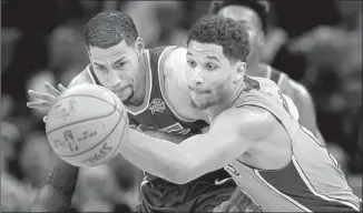  ?? Rich Pedroncell­i Associated Press ?? THE LAKERS’ Josh Hart, right, and Sacramento’s Garrett Temple scramble for the ball during a game in February. Hart wanted to return to the Lakers’ lineup on Wednesday but wasn’t cleared.