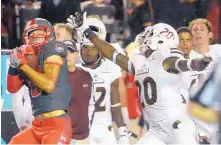  ?? GREG SORBER/JOURNAL ?? UNM’s Q’ Drennan (9) catches a pass in front of Louisiana Monroe’s Justin Backus during Saturday night’s game.