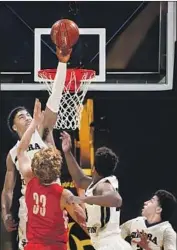  ?? Kent Nishimura Los Angeles Times ?? SIERRA CANYON’S K.J. Martin goes above the rim to block a shot by Mater Dei’s Reagan Lundeen.