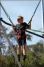  ?? MARIAN DENNIS – DIGITAL FIRST ?? A boy takes a turn bouncing around on bungee cordsMEDIA Saturday during the Ninth Annual Red Corner benefit. Kids enjoyed lots of activities at the event, including face painting, pumpkin decorating and seasonal games.