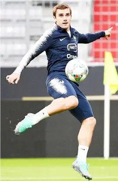  ??  ?? Griezmann kicks the ball during a training session of this players in Munich, southern Germany. — AFP photo