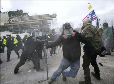  ?? JULIO CORTEZ — THE ASSOCIATED PRESS ?? Trump supporters try to break through a police barrier Wednesday in the attack on the Capitol.