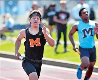  ?? TIM MARTIN/THE DAY ?? Montville’s Gennaro Davis, left, runs the anchor leg in the 4x400 relay during the Ledyard Relays on Saturday. He teamed with Daltyn Butler, Greg Clark and Nick Donnell to win the event.