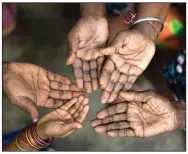  ?? (AP) ?? Women from age 6 to 102 in a family that has worked on a palm oil plantation in Malaysia for five generation­s hold out their hands in this file photo. The U.S. said it will ban all shipments of palm oil from one of the world’s biggest producers after finding indicators of forced labor and other abuses on plantation­s that feed into the supply chains of some of America’s most famous food and cosmetic companies.