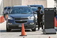  ?? Jon Shapley / Staff file photo ?? People drop off mail ballots at NRG Park in October. Texas is one of 16 states that require voters to have an excuse to vote by mail.