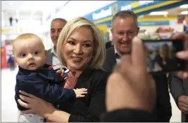  ?? PETER MORRISON — THE ASSOCIATED PRESS ?? Michelle O'Neill, Sinn Fein leader in Northern Ireland, holds Setanta Maguibhir while out canvassing in West Belfast, Northern Ireland, on Tuesday.