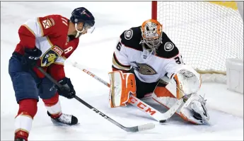  ?? LYNNE SLADKY — THE ASSOCIATED PRESS ?? Florida Panthers left wing Jonathan Huberdeau (11) sets up a shot to score a goal against Anaheim Ducks goaltender John Gibson during overtime in game earlier this month in Sunrise, Fla.