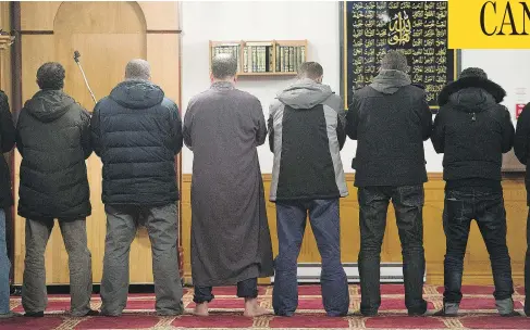  ?? GRAHAM HUGHES FOR NATIONAL POST ?? Muslim men at an Islamic centre in Montreal. Many places of worship of minority religions are technicall­y illegal because of restrictiv­e zoning.