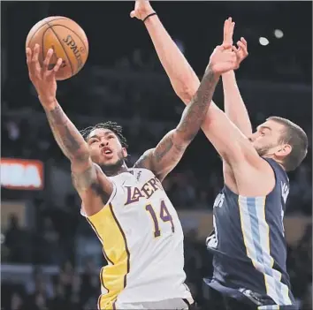 ?? Luis Sinco Los Angeles Times ?? LAKERS FORWARD Brandon Ingram, maneuverin­g past Marc Gasol of the Memphis Grizzlies in a game last month, scored a career-high 32 points last week in a loss to the Golden State Warriors.