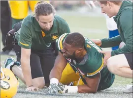  ?? The Canadian Press ?? Edmonton Eskimos running back John White is injured during first-half CFL action against the Montreal Alouettes in Edmonton on Friday.