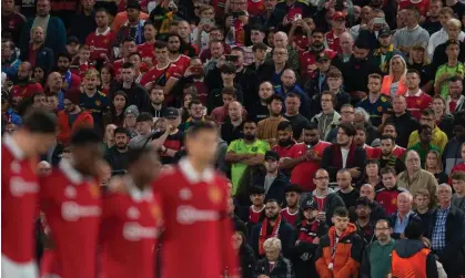  ?? Photograph: Peter Powell/EPA ?? Manchester United fans stand in silence to honour the Queen before the club’s Europa League game against Real Sociedad on Thursday.