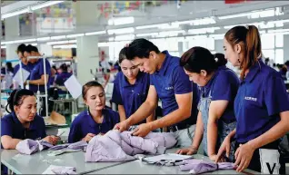  ?? DING LEI / XINHUA ?? A technician checks the quality of products at a garment company in Hotan, Xinjiang Uygur autonomous region, on Aug 25.