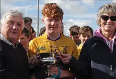  ??  ?? Josh Sheil receives the cup from Ger Hore and Marguerite Furlong.