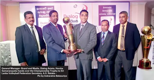  ??  ?? General Manager- Brand and Media, Dialog Axiata, Harsha Samaranaya­ka hands over the Championsh­ip Trophy to Sri Lanka Volleyball Federation Secretary, A.S. Nalaka -
Pic by Indraratne Balasuriya