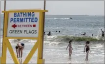  ?? JOHNNY MILANO — THE NEW YORK TIMES ?? A lifeguard on a Jet Ski at Jones Beach monitors for sharks in New York on Friday.