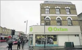  ?? REUTERS FILE ?? People walk past an Oxfam store in Dalston, east London.