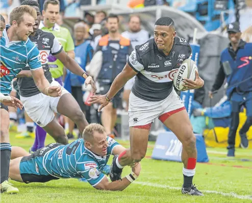  ?? Picture:Gallo Images ?? Leolin Zas, who scored two tries for Cell C Sharks, evades Griquas’ AJ Coertzen during yesterday’s Currie Cup fixture in Kimberley.