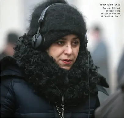  ??  ?? DIRECTOR’S GAZE Marjane Satrapi observes the action on the set of “Radioactiv­e.”