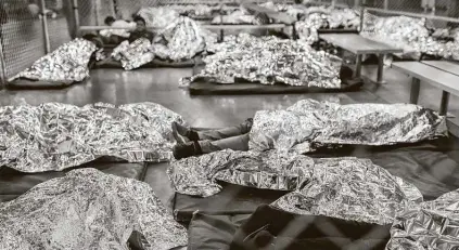  ?? Carolyn Van Houten / Washington Post file photo ?? Male minors rest under Mylar blankets in the Border Patrol Central Processing Center in Mcallen in August 2019.