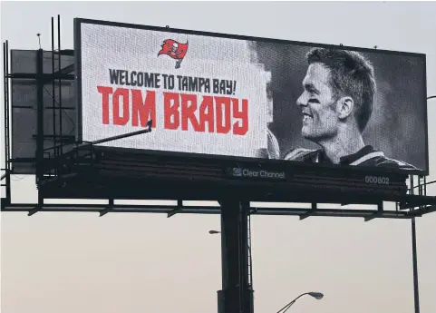  ?? USA TODAY SPORTS ?? New Buccaneers quarterbac­k Tom Brady is welcomed on a billboard in Tampa Bay.