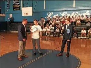  ?? NICHOLAS BUONANNO — NBUONANNO@ TROYRECORD. COM ?? Students at La Salle Institute present former religion teacher and current principal at Lourdes Academy Steve Dole with a $ 3,000check to help his secretary in Florida during a Friday afternoon homecoming pep rally at La Salle.