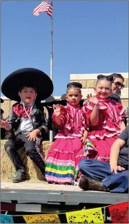  ?? RECORDER PHOTO BY ESTHER AVILA ?? Dressed as a little Charro, Mexican cowboy Jonathan Ceballos, along with two young girls, wave to people along the parade route Saturday during the 49th annual CHMA Cinco de Mayo Parade.