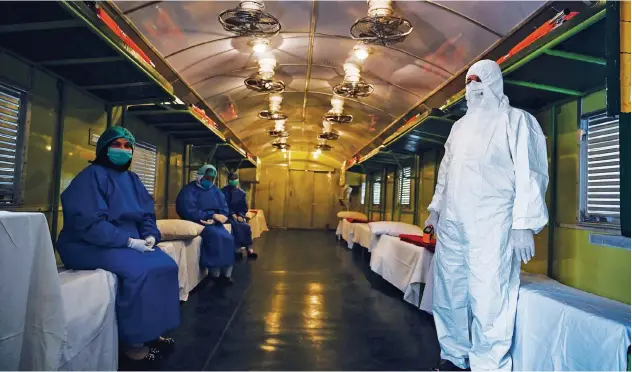  ?? Agence France-presse ?? ↑
Medical staff is seen in a train coach prepared as a temporary quarantine facility in Rawalpindi on Tuesday.