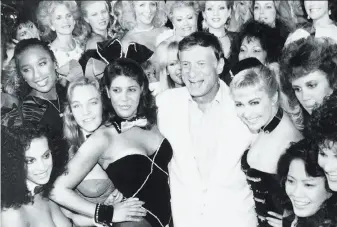  ?? Associated Press 1986 ?? Playboy founder Hugh Hefner is surrounded by current and former Playboy bunnies in their distinctiv­e attire at the Playboy Club in Los Angeles, days before the club closed in 1986.