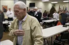  ?? MARK YLEN/ALBANY DEMOCRAT-HERALD VIA AP ?? Pearl Harbor survivor David Russell, 98, stands for “Taps” during a memorial service at the American Legion Post 10 in Albany, Ore., Friday. Russell survived the attack by jumping from the stricken USS Oklahoma onto the USS Maryland during the attack in Hawaii.