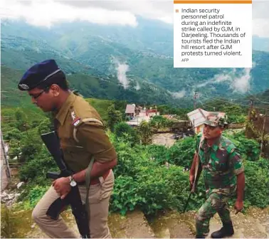  ?? AFP ?? Indian security personnel patrol during an indefinite strike called by GJM, in Darjeeling. Thousands of tourists fled the Indian hill resort after GJM protests turned violent.
