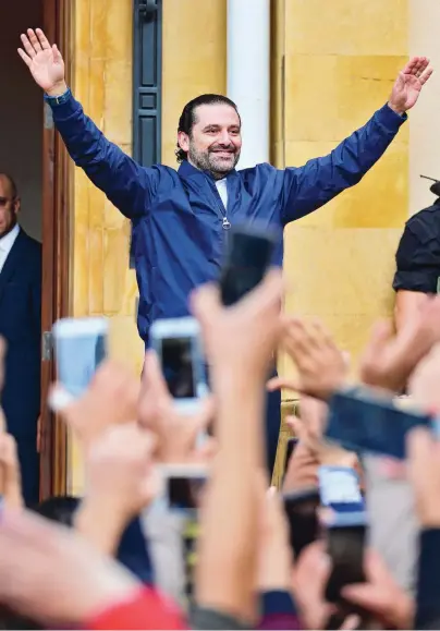  ??  ?? Premier Saad Hariri begroet zijn aanhang, woensdag bij aankomst in Beiroet.