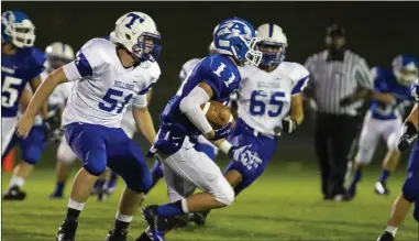  ?? Contribute­d photo ?? Armuchee’s Brody Everett (11) gets by Trion’s Royce Hogg (51) during Friday night’s loss to the Bulldogs.