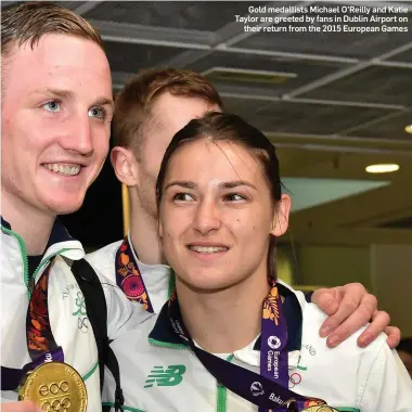  ??  ?? Gold medallists Michael O’Reilly and Katie Taylor are greeted by fans in Dublin Airport on their return from the 2015 European Games