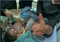  ?? AFP ?? Babies arrive at a clinic after a suspected chemical attack. —