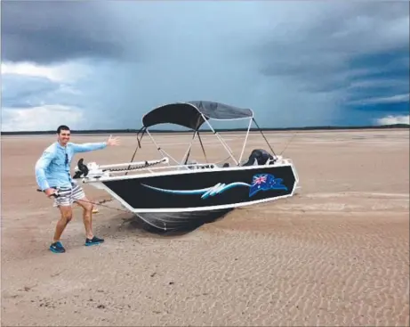  ??  ?? James Van Meurs sent in this photograph of his mate Oscar ‘‘Oscarbosca’’ Brumby-Rendell stuck at Shoal Bay with a cracking storm in the background. Fishing enthusiast­s are reminded to closely watch the boating weather and tides over Christmas