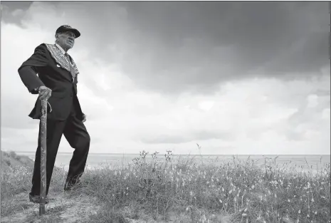  ?? VIRGINIA MAYO/AP PHOTO ?? Charles Norman Shay, a World War II D-Day veteran and Penobscot Elder from Maine, poses on the dune overlookin­g Omaha Beach prior to a ceremony at his memorial in Saint-Laurent-sur-Mer, Normandy, France, on Friday.