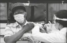  ?? YUKI IWAMURA VIA AP ?? IN THIS JAN. 15 FILE PHOTO, a nursing home resident receives the COVID-19 vaccine by a CVS Pharmacist at Harlem Center for Nursing and Rehabilita­tion in New York.