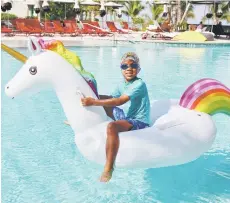  ?? ?? Zephyr Martell rides a unicorn float in the Cayman Islands in 2019.