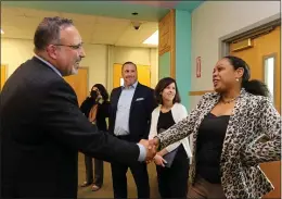  ?? ?? WELCOME!: U.S. Secretary of Education Miguel Cardona, visiting Lowell High School, greets Lowell Public Schools Chief Equity & Engagement Officer Latifah Phillps, as Superinten­dent Joel Boyd and Assistant Head of School Jill Rothschild look on.