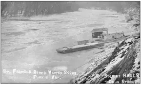  ?? (Courtesy of the Butler Center for Arkansas Studies, Central Arkansas Library System) ?? A barge and a houseboat float on the St. Francis River at Parkin (Cross County) during winter.