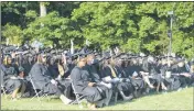  ?? STAFF PHOTO BY JAMIE ANFENSON-COMEAU ?? Graduating students raise their hands when asked how many have received a scholarshi­p from the College of Southern Maryland during the college’s 58th spring commenceme­nt Thursday afternoon.