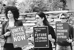  ??  ?? Supporters of Unite Cyprus Now demonstrat­e ahead of peace talks on divided Cyprus under the supervisio­n of the United Nations in the alpine resort of Crans-Montana, Switzerlan­d. — Reuters photo