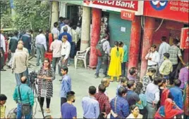  ?? MINT/FILE ?? People queue up outside ATMs to withdraw money after demonetisa­tion. The note ban took place on November 8 last year