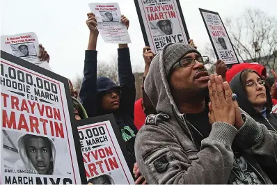  ?? The Associated Press ?? Demonstrat­ors pray during the 2012 Million Hoodie March in Union Square in New York. The killing of Trayvon Martin at the hands of a stranger still reverberat­es 10 years later — in protest, in partisansh­ip, in racial reckoning and reactionar­y response, in social justice and social media.