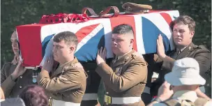  ??  ?? Soldiers from The Royal Regiment of Fusiliers carry Captain Walker’s coffin